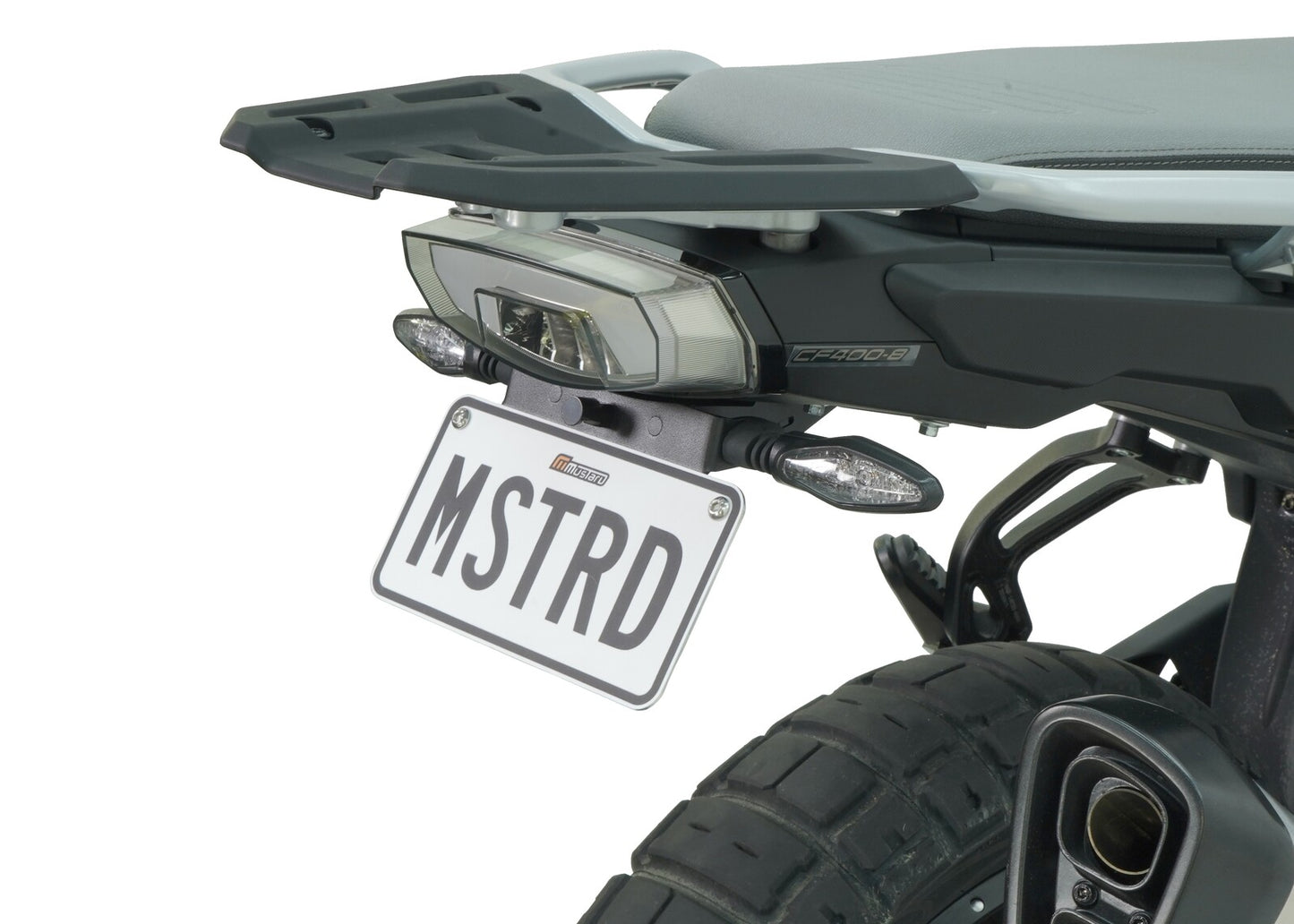 A motorcycle fender eliminator kit, featuring a black aluminum license plate holder with an LED light, mounted on the rear of a motorcycle.