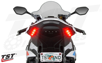 BMW S1000RR Motorcycle with red integrated tail light and TST Industries branding on a white background