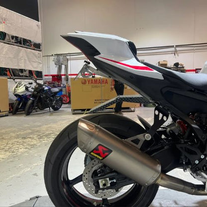 A side on photo of a yamaha R9 tail tidy installed, in the warehouse of a Yamaha dealership.